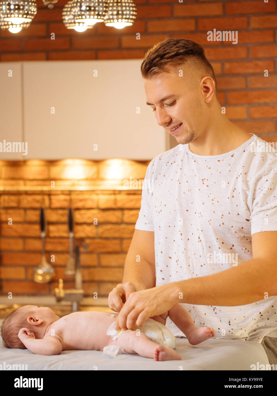 father is changing nappy to his baby boy Stock Photo Alamy