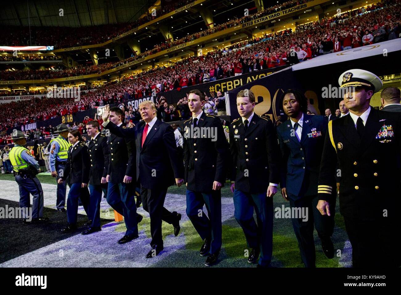U.S. President Donald Trump waves as he walks on to the field for the NCAA College Football Playoff National Championship between the University of Alabama Crimson Tide and the University of Georgia Bulldogs January 8, 2018 in Atlanta, Georgia. Stock Photo