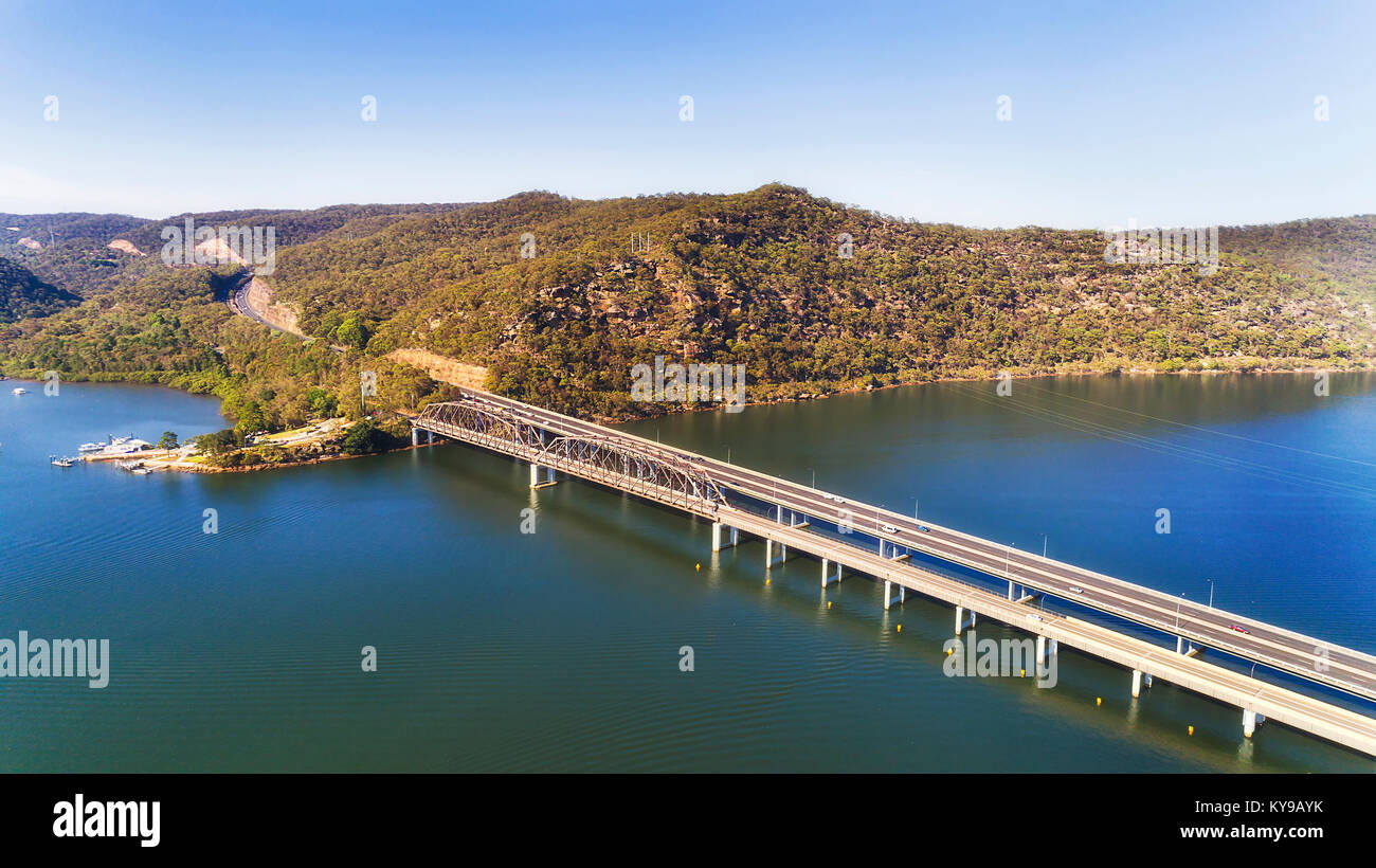 Motor vehicle multi lane bridges part of Motorway 1 Sydney to Newcastle over Hawkesbury river on NSW Central coast in australia over still flowing wat Stock Photo