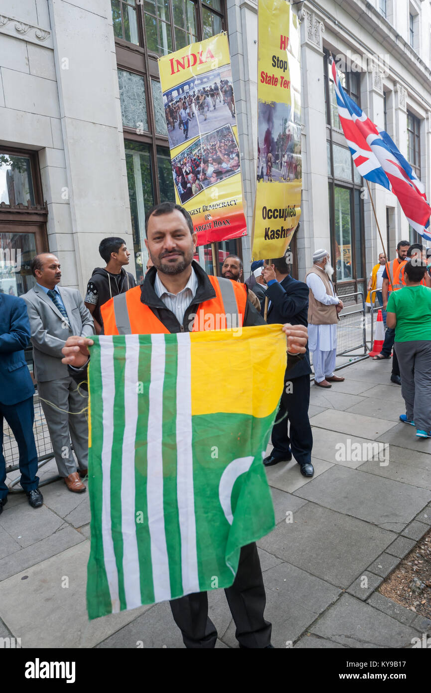 A Man Holds The Kashmir Flag At National Protest Against Indian a-man-holds-the-kashmir-flag-at-national-protest-against-indian