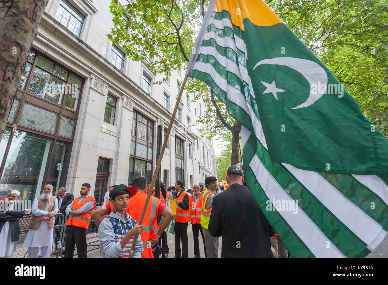 A Young Boy Holds A Larrge Kashmir Flag At The Kashmiri National a-young-boy-holds-a-larrge-kashmir-flag-at-the-kashmiri-national