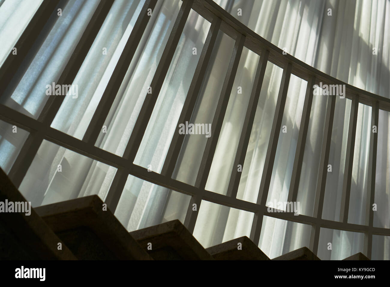 Railing And Light And Shadow Patterns Against Drapes Stock Photo
