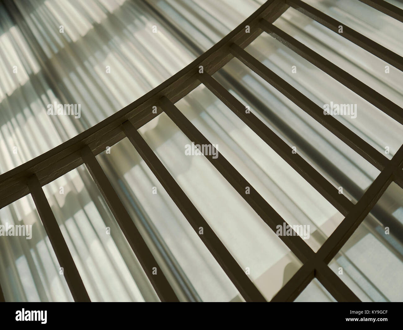 Railing And Light And Shadow Patterns Against Drapes Stock Photo