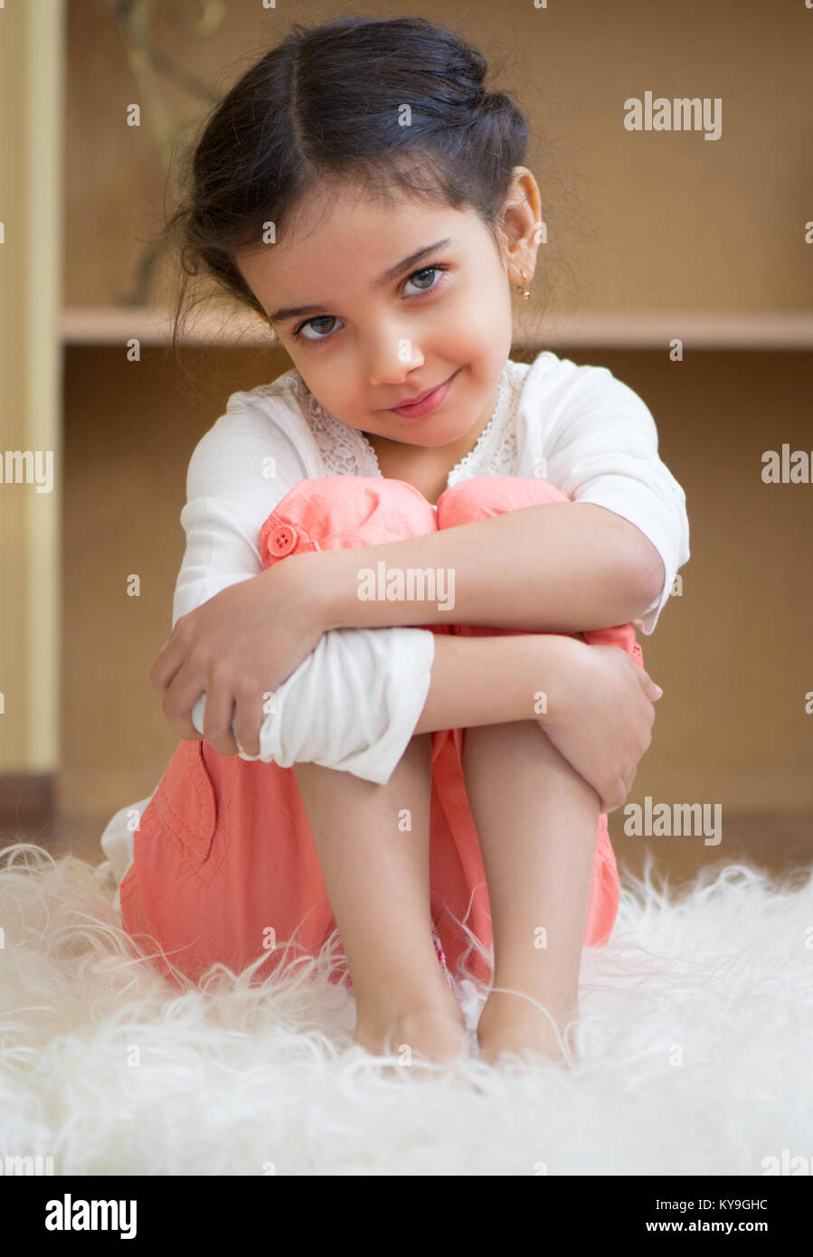 Portrait of cute little hispanic girl sittin on carpet at home Stock ...