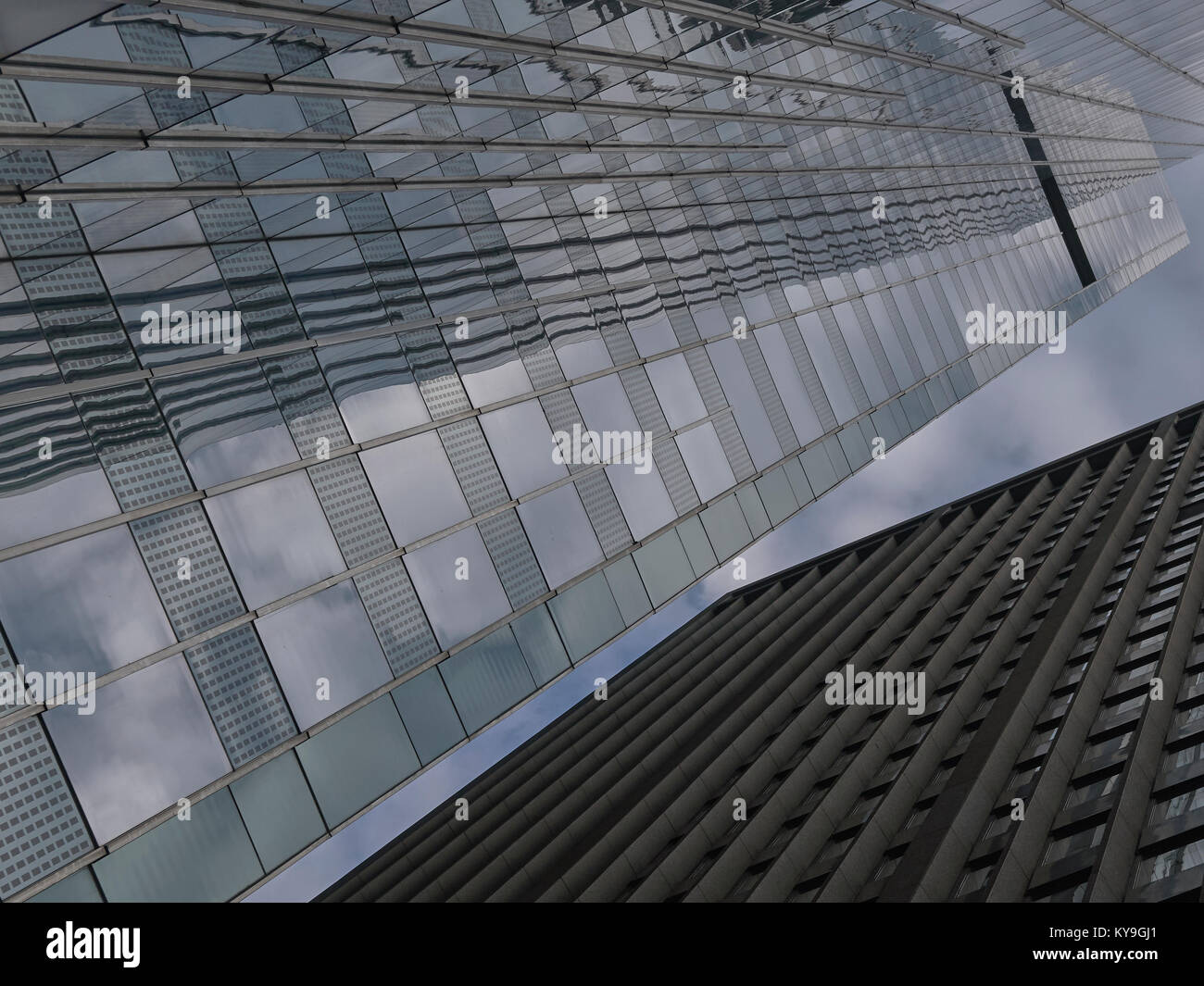 looking up at two Chicago buildings with reflections of clouds in glass surface Stock Photo