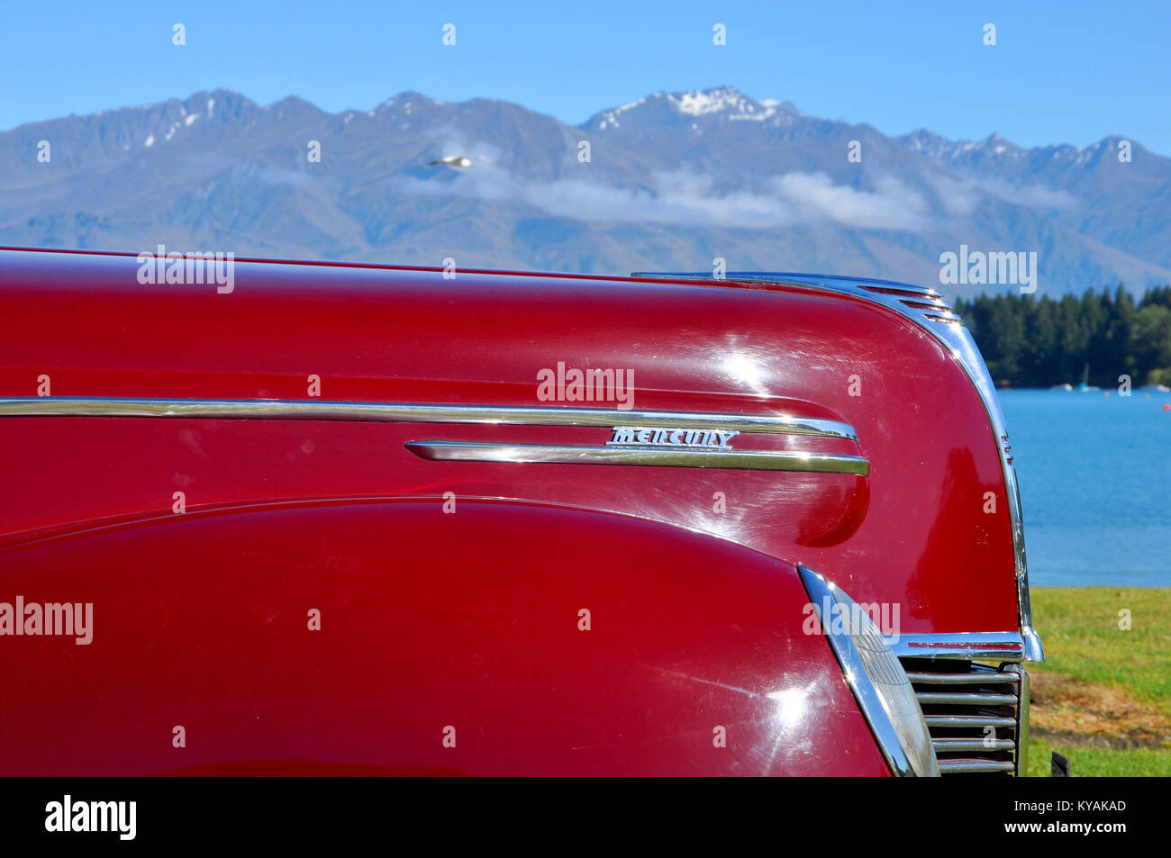 Mercury Eight vintage car, with Lake Wanaka and mountains beyond. Otago region of New Zealand Stock Photo