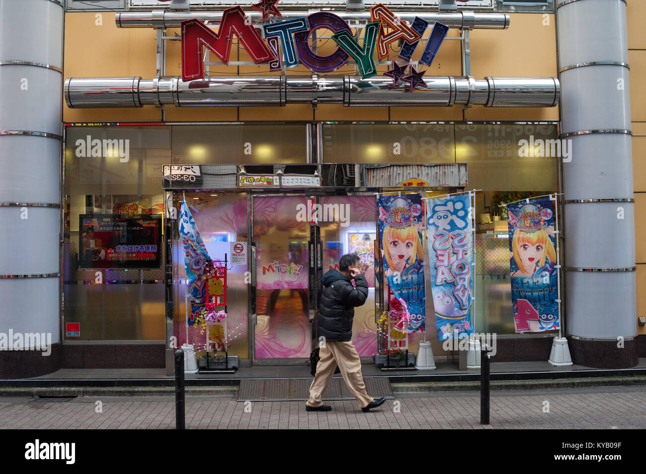 31.12.2017, Tokyo, Japan, Asia - A man walks by a Pachinko parlour in Tokyo on an early morning. Stock Photo