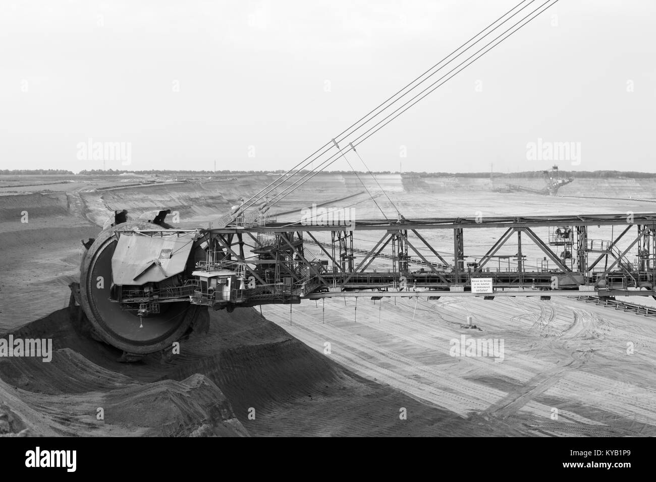 A lignite surface mine with a giant bucket-wheel excavator, one of the worlds largest moving land vehicles in black and white. The wheel has a diamete Stock Photo