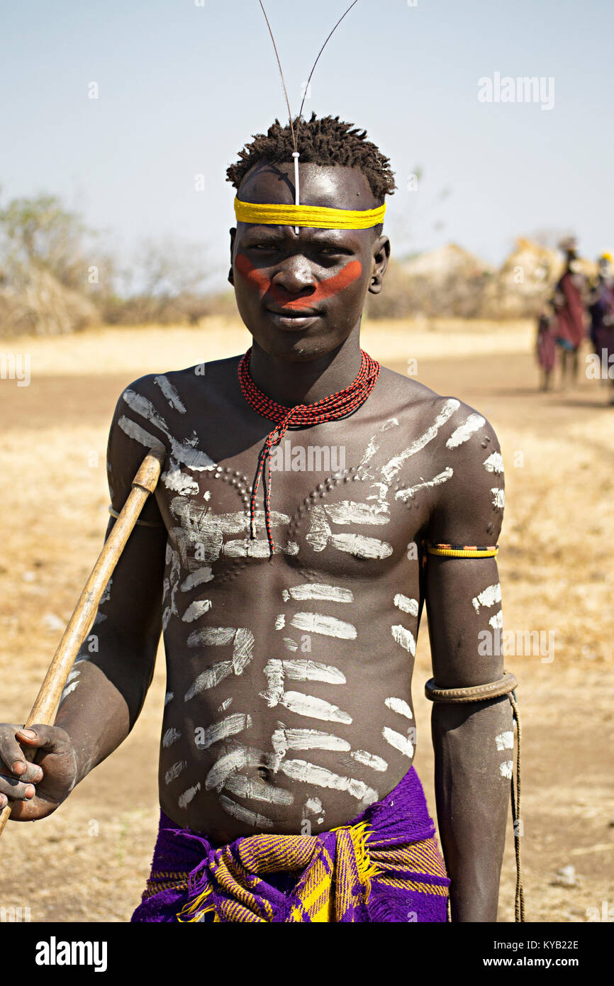 Mursi warrior shows scarification and body painting in lower Omo valley - Ethiopia. © Antonio Ciufo Stock Photo