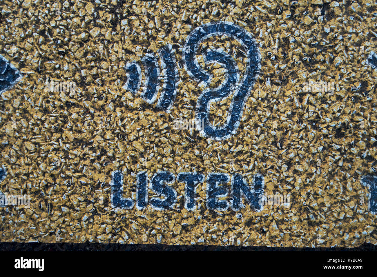 Listen symbol on asphalt path Stock Photo - Alamy