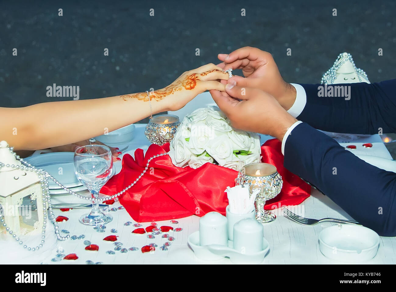He put her wedding rings on her finger. Groom put a ring on finger of