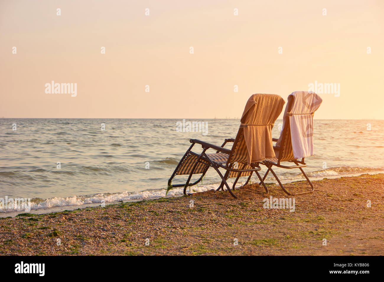 Deck chairs with towels on backrest on the seashore Stock Photo Alamy