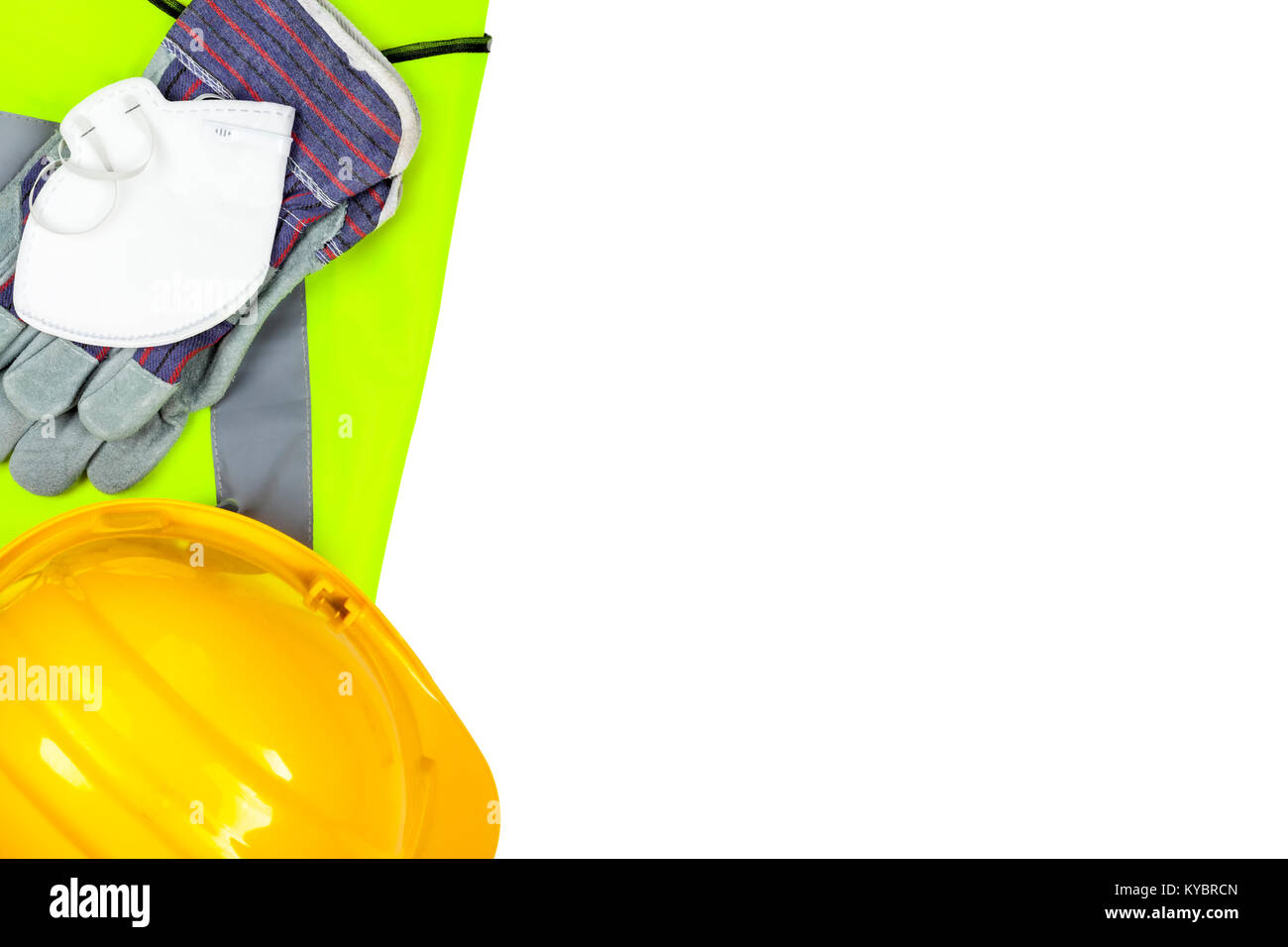 Yellow hi vis vest and hard hat with safety gloves and a dust mask isolated on a pure white background Stock Photo