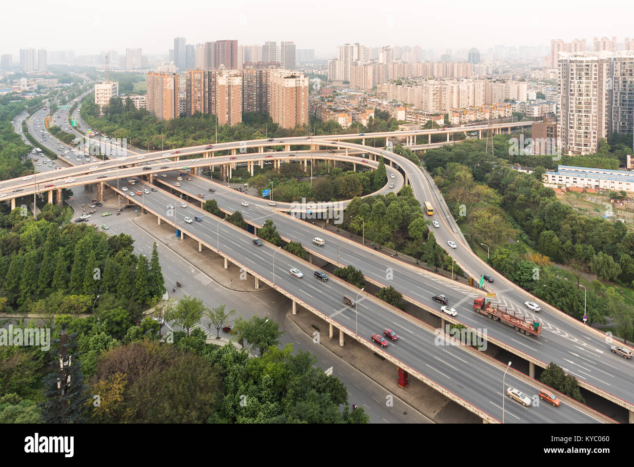 Car traffic on a flyover with residential buildings aerial view Stock Photo