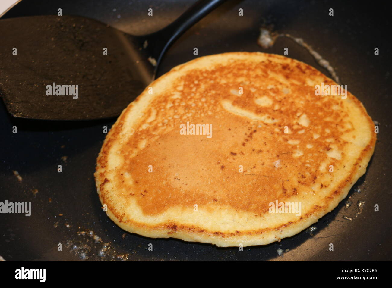 Pancakes cooking in a frying pan Stock Photo Alamy