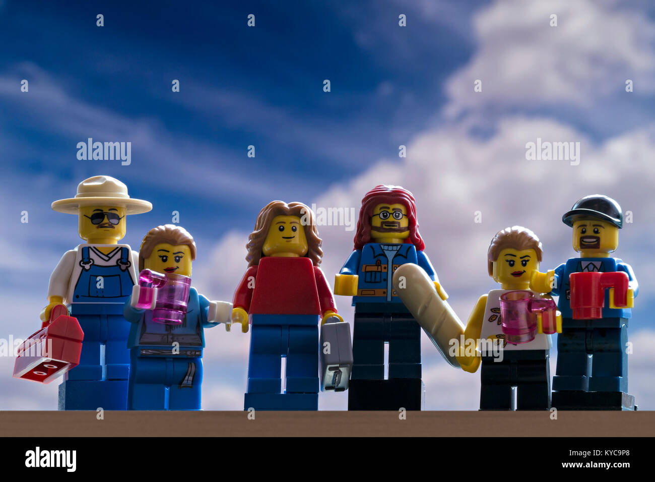 Family of Lego people mini-figures against blue sky background Stock Photo