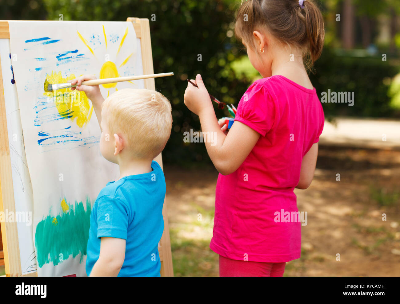 Pre-school children painting at the park Stock Photo