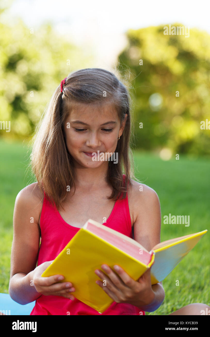 Little girl hold yellow book Stock Photo
