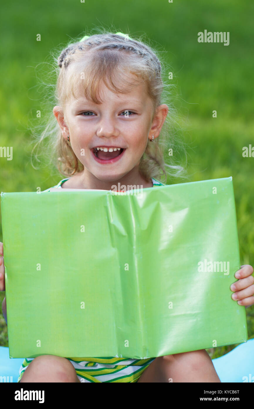 Little girl hold green book Stock Photo