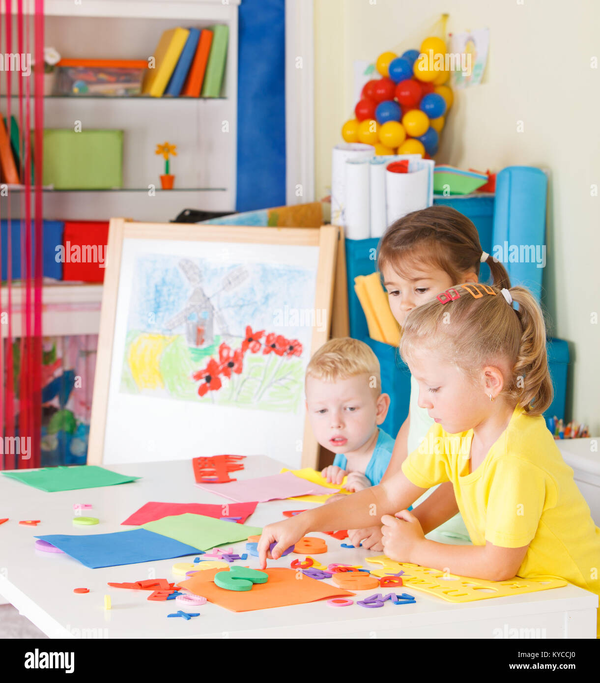 Three preschoolers in the classroom Stock Photo - Alamy
