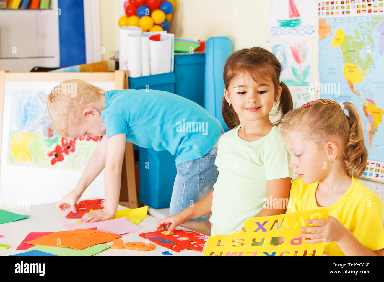 Three preschoolers in the classroom Stock Photo