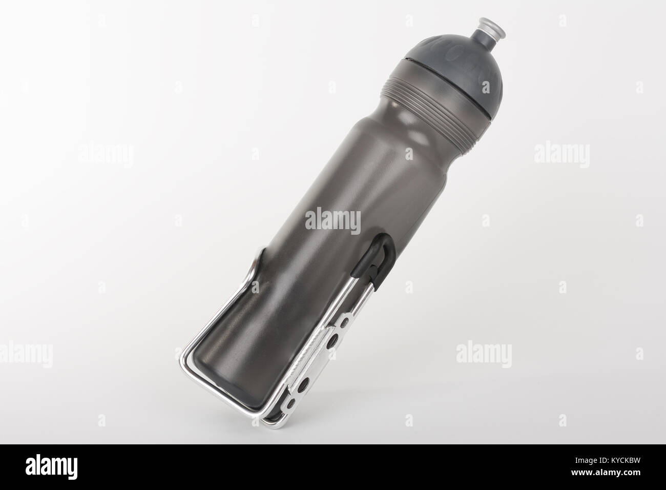 Grey bike water bottle inserted to holder, studio photo, isolated on
