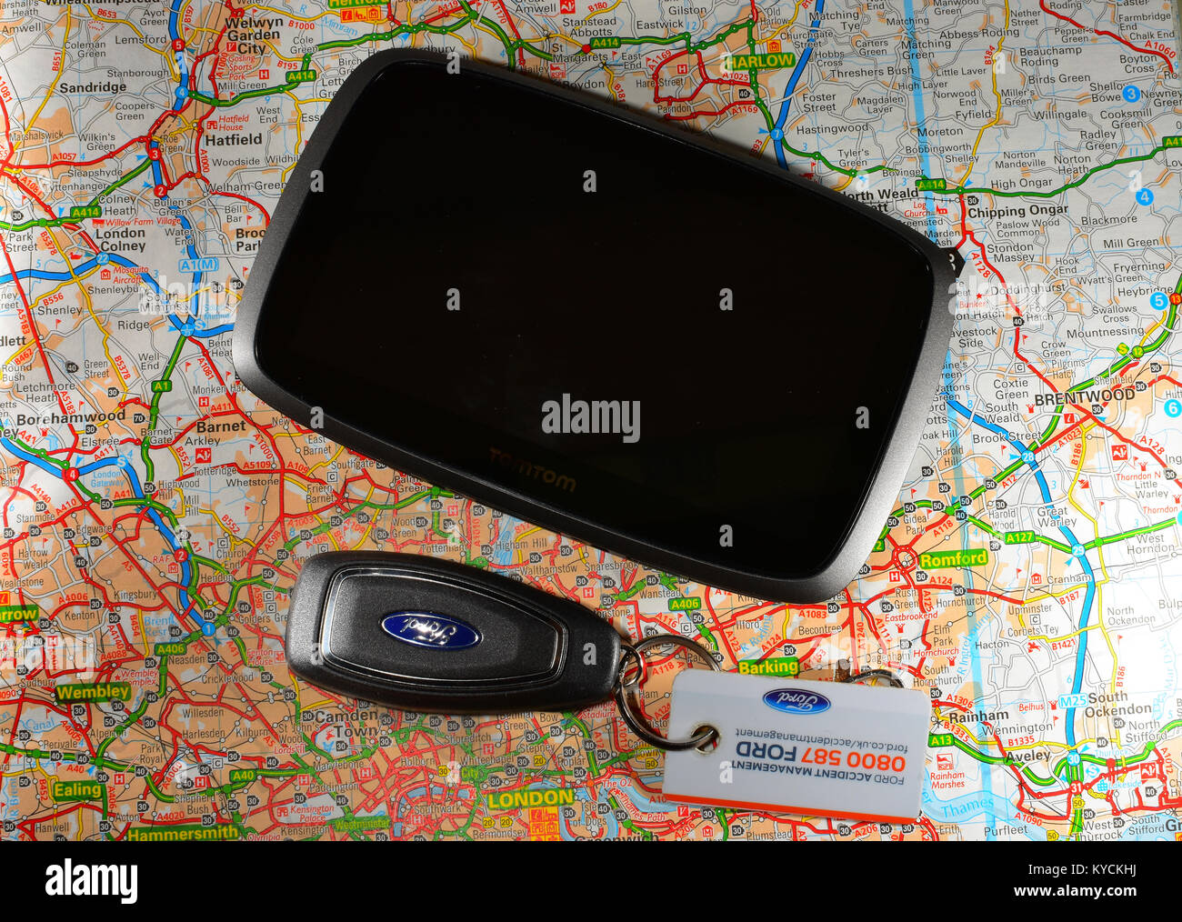 Tom-tom Sat nav with car keys and a road map Stock Photo