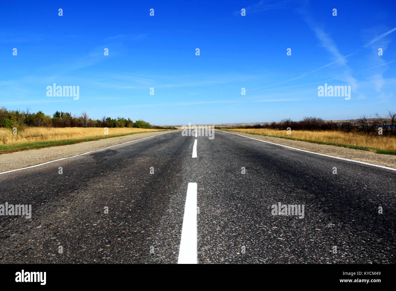 Summer landscape with line of road and blue sky Stock Photo - Alamy