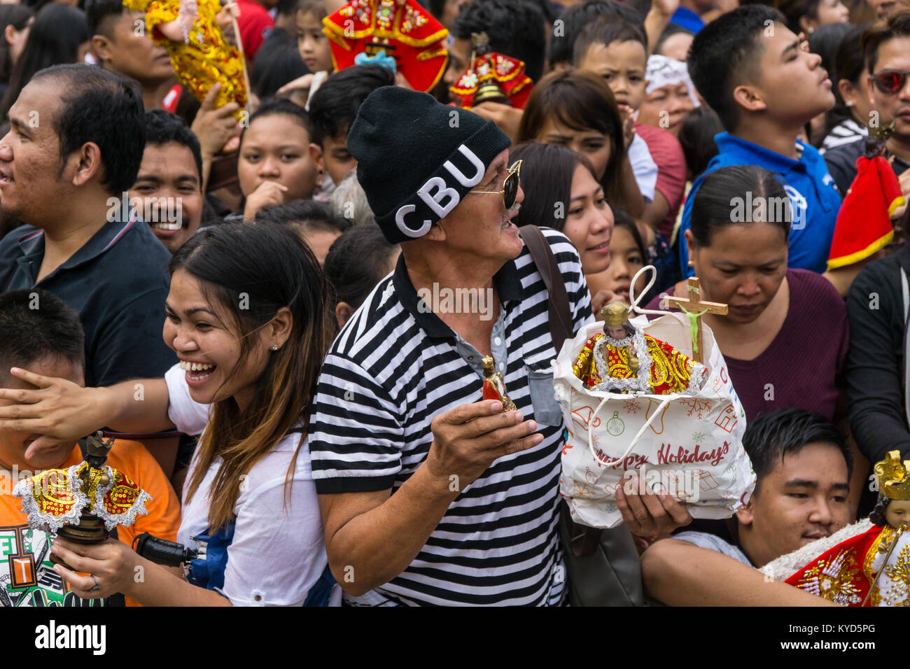 Cebu City, Philippines. 14th January, 2018. A man waits with his Santo Nino figurines in the hope they will be doused and blessed by Priests with Holy Water.As part of the Sinulog 9 day religious festival,Filipino Catholics gather for early morning Sunday mass bringing with them Santo Nino figurines,replicas of the child Jesus.The belief in this Effigy dates back to the time of explorer Ferdinand Magellan who gave the original figurine as a gift when he landed in 1521 at Cebu. Credit: imagegallery2/Alamy Live News Stock Photo