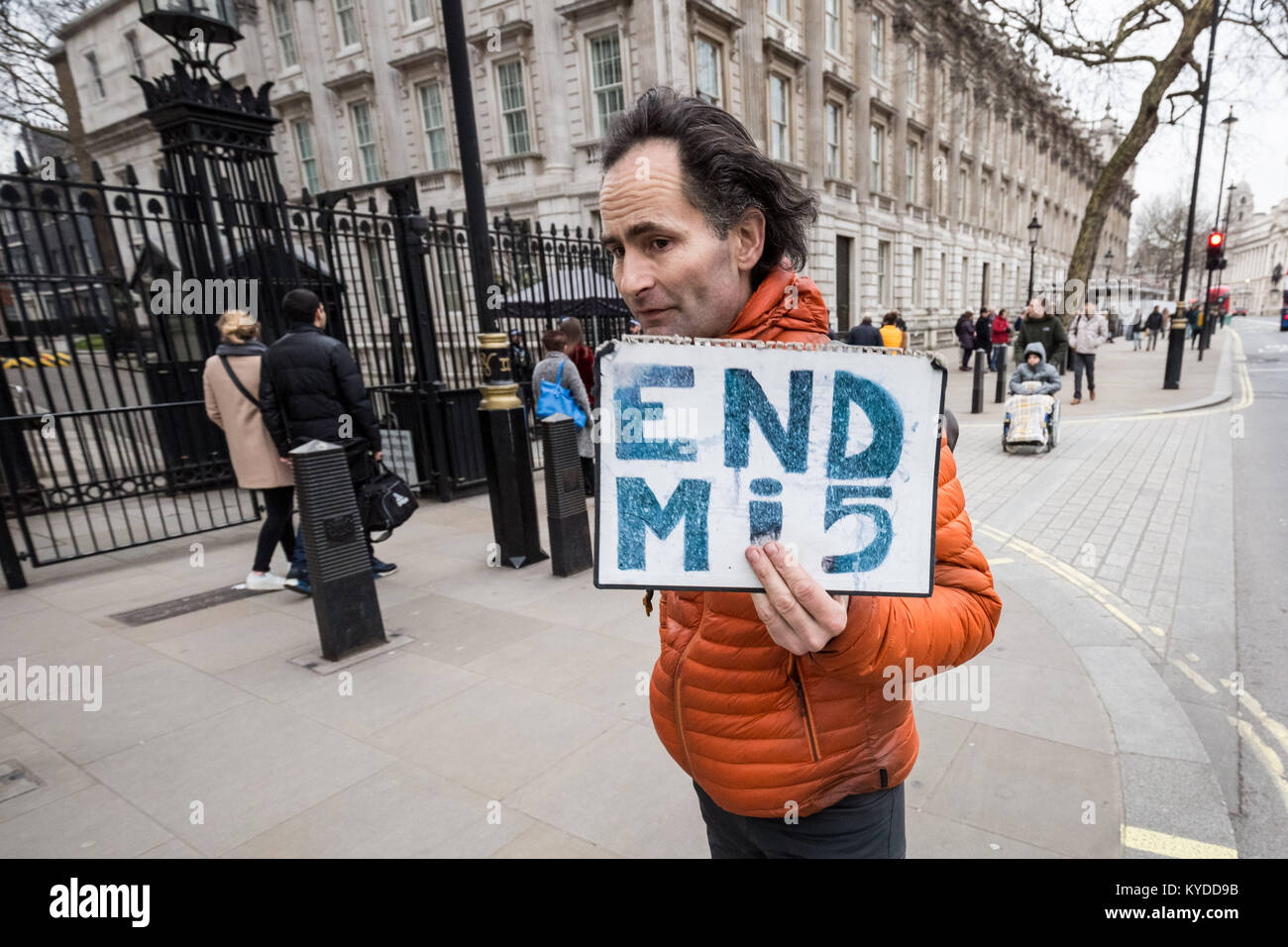 Downing Street, London, UK. 14th Jan, 2018. A lone protestor outside Downing Street gates holds a sign that reads 'END Mi5' referring to the United Kingdom's domestic secret intelligence agency. Credit: Guy Corbishley/Alamy Live News Stock Photo