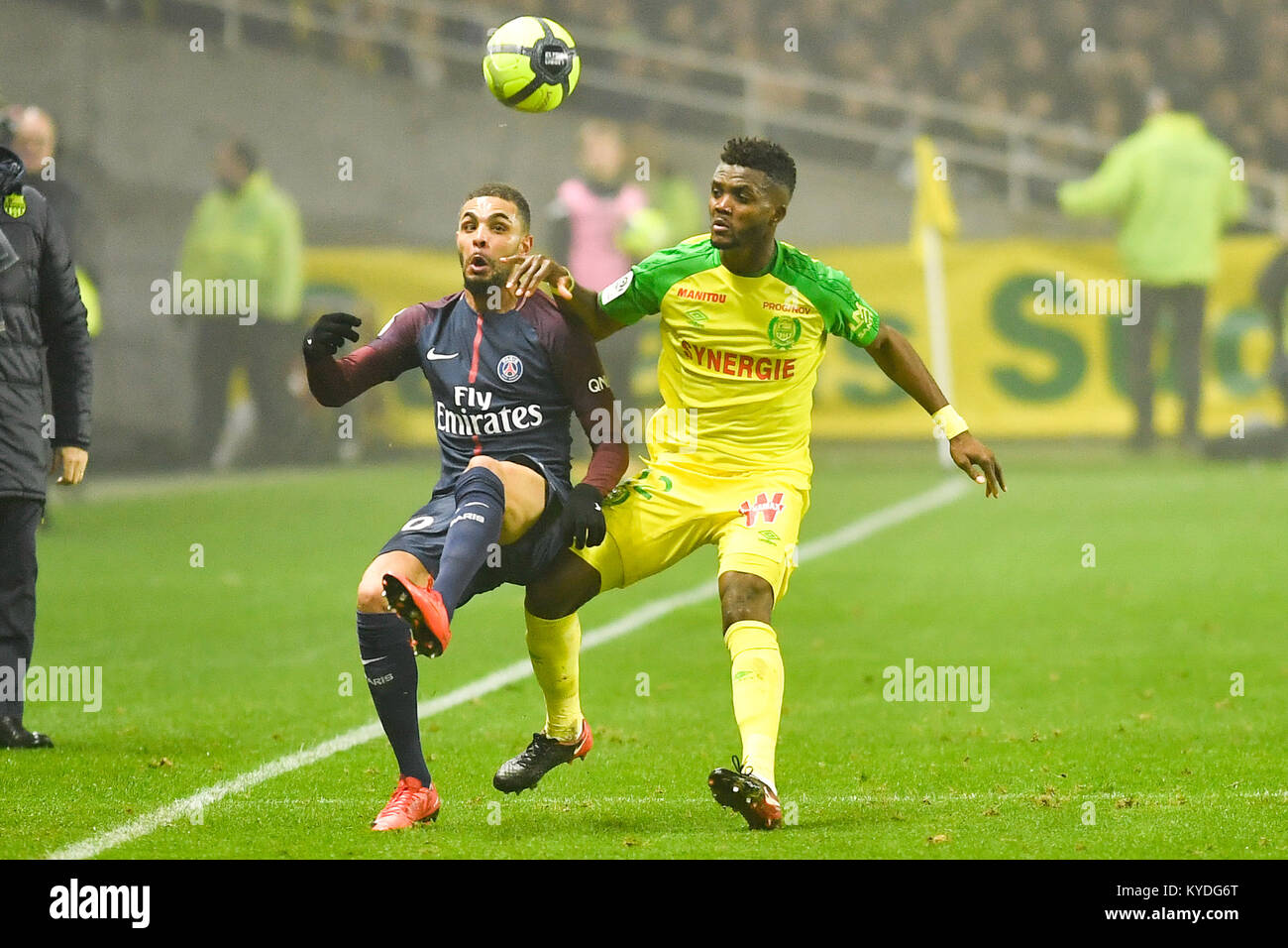 Nantes. 14th Jan, 2018. Chidozie Awaziem (R) from Nantes competes with Layvin Kurzawa from Paris Saint-Germain during the match between Nantes and Paris Saint-Germain of French Ligue 1 2017-2018 season round 20 in Nantes, France on Jan. 14, 2018. Paris Saint-Germain won 1-0. Credit: Chen Yichen/Xinhua/Alamy Live News Stock Photo