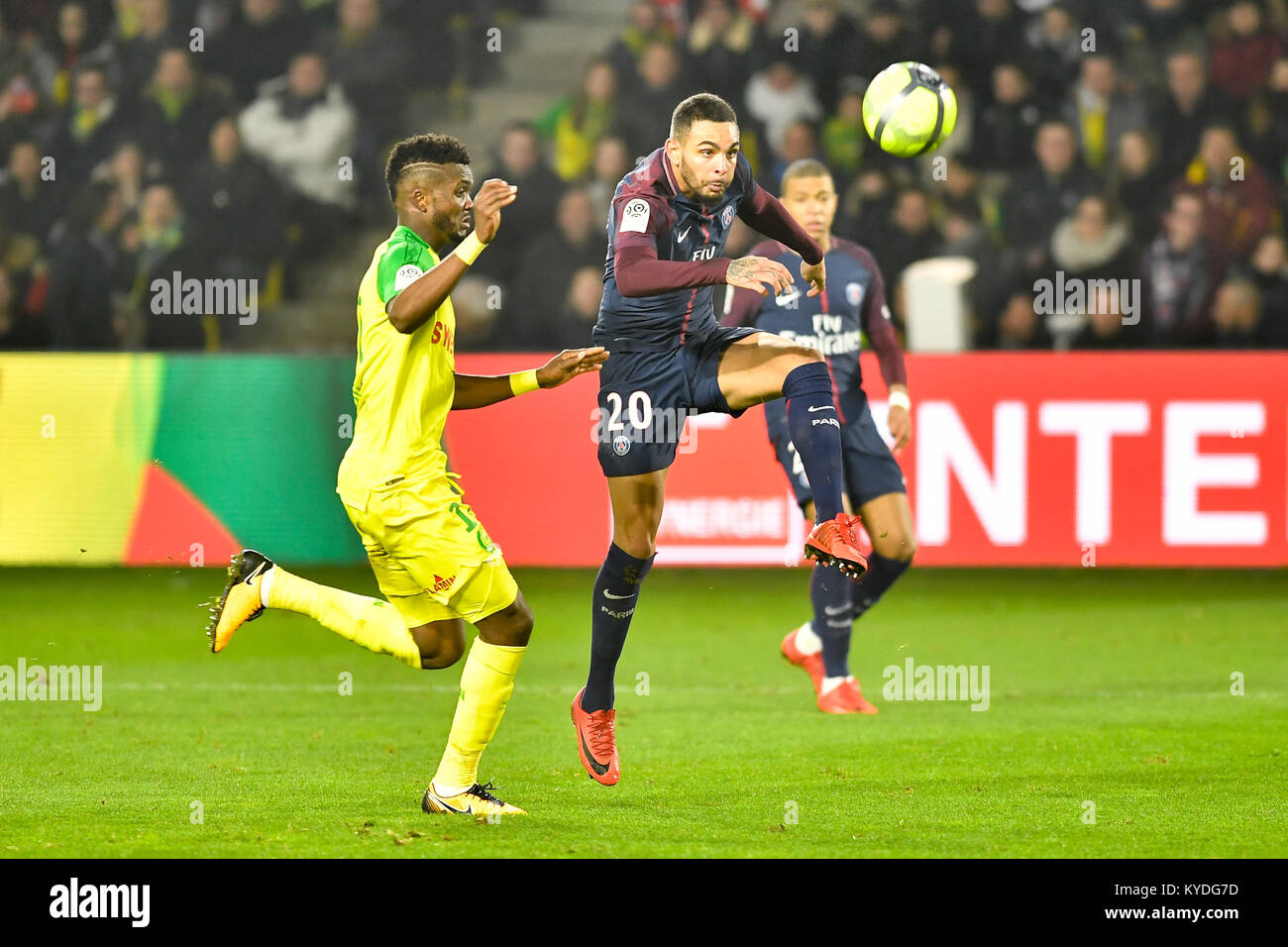 Nantes. 14th Jan, 2018. Chidozie Awaziem (L) from Nantes competes with Kylian Mbappe from Paris Saint-Germain during the match between Nantes and Paris Saint-Germain of French Ligue 1 2017-2018 season round 20 in Nantes, France on Jan. 14, 2018. Paris Saint-Germain won 1-0. Credit: Chen Yichen/Xinhua/Alamy Live News Stock Photo