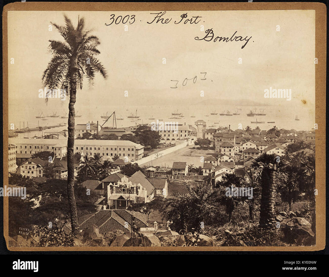 A historical photograph by Francis Frith, depicting the port of Bombay, showcasing the bustling trade activity and the architectural features of the port area in the 19th century. Stock Photo