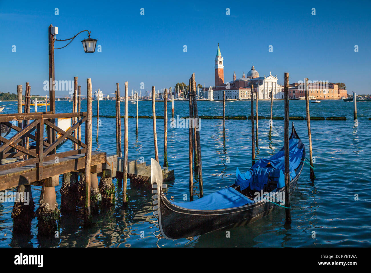 Parked gondolas and the Church of San Giorgio Maggiore in Veneto, Venice, Italy, Europe, Stock Photo