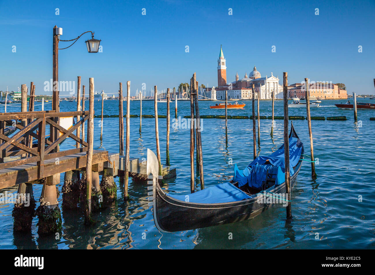 Parked gondolas and the Church of San Giorgio Maggiore in Veneto, Venice, Italy, Europe, Stock Photo