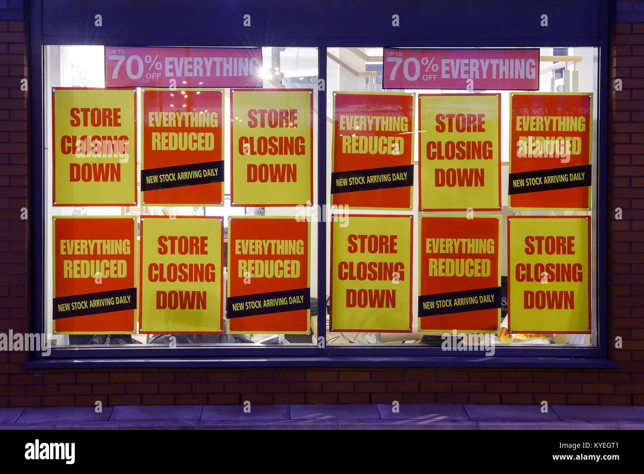 Store Closing Down posters in a shop window Stock Photo