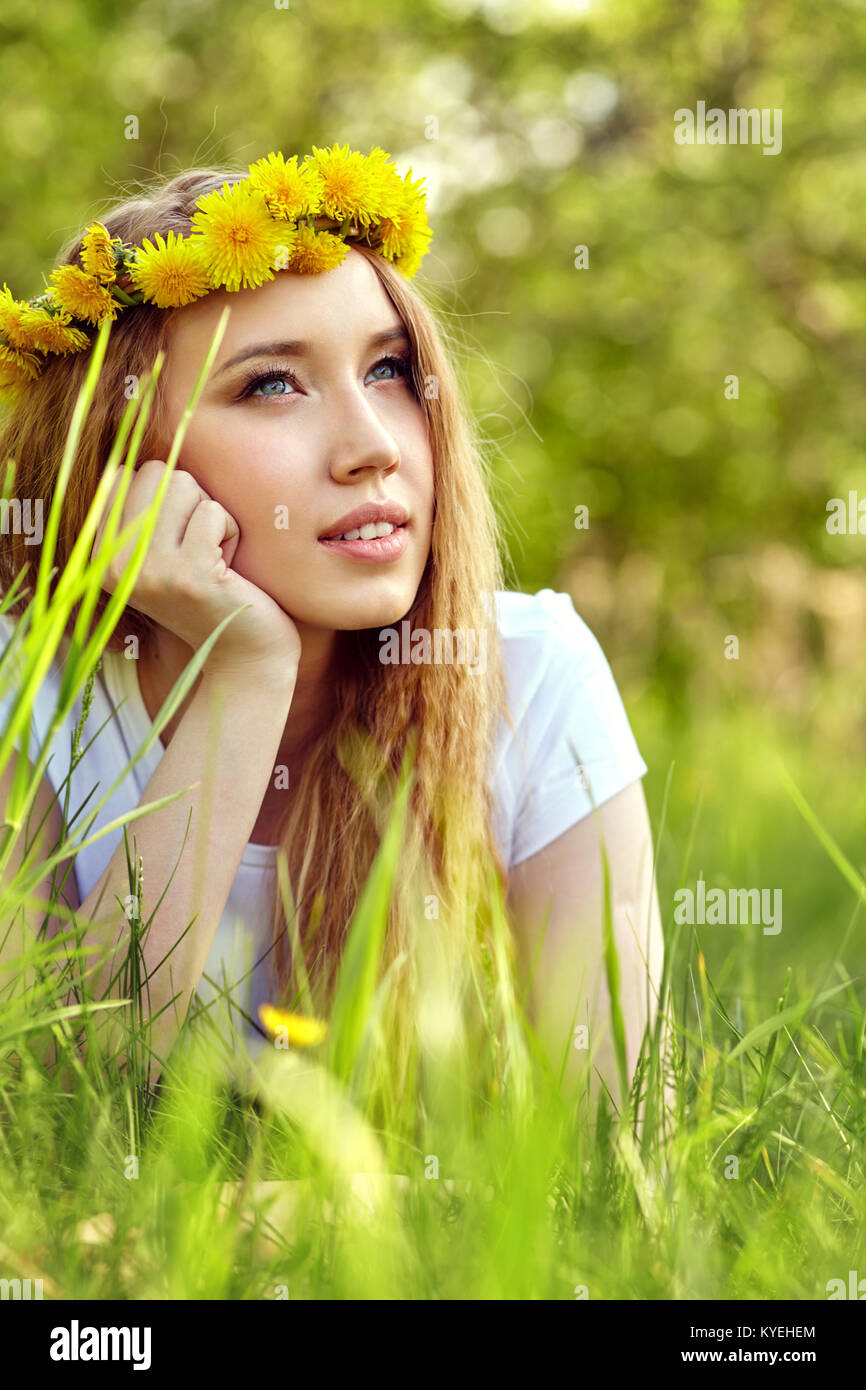 cute girl in a wreath of dandelions Stock Photo