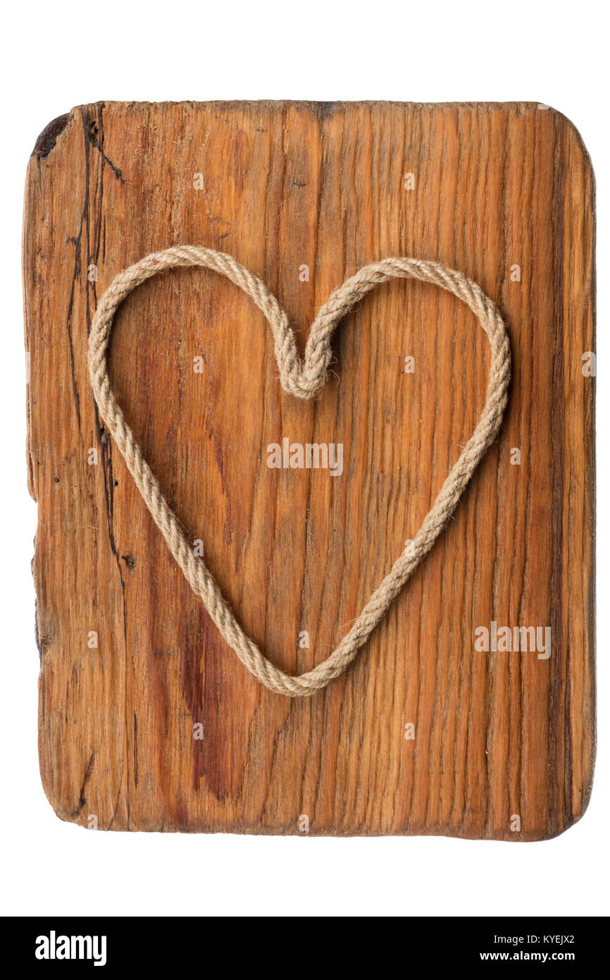 Classic heart made of rope lies on the old wooden frame, isolated on ...