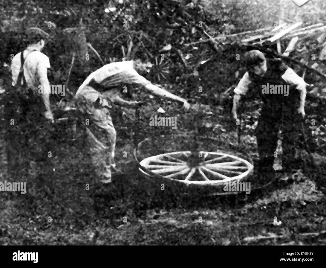 British Wheelwrights at work in the 1940's fitting a tyre on a wheel Stock Photo