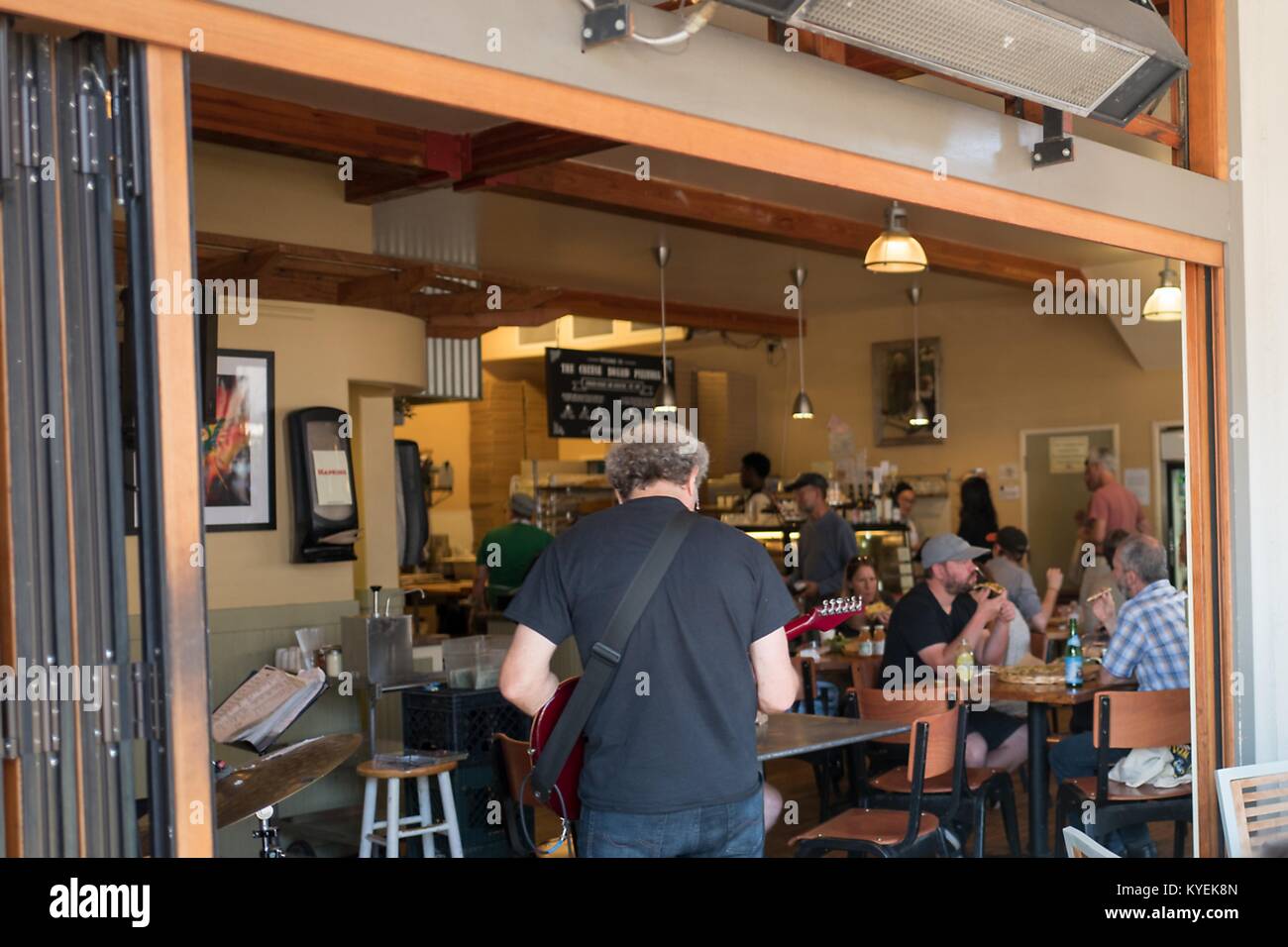 A musician plays at Cheese Board Pizza, a workerowned collective pizza shop in the Gourmet