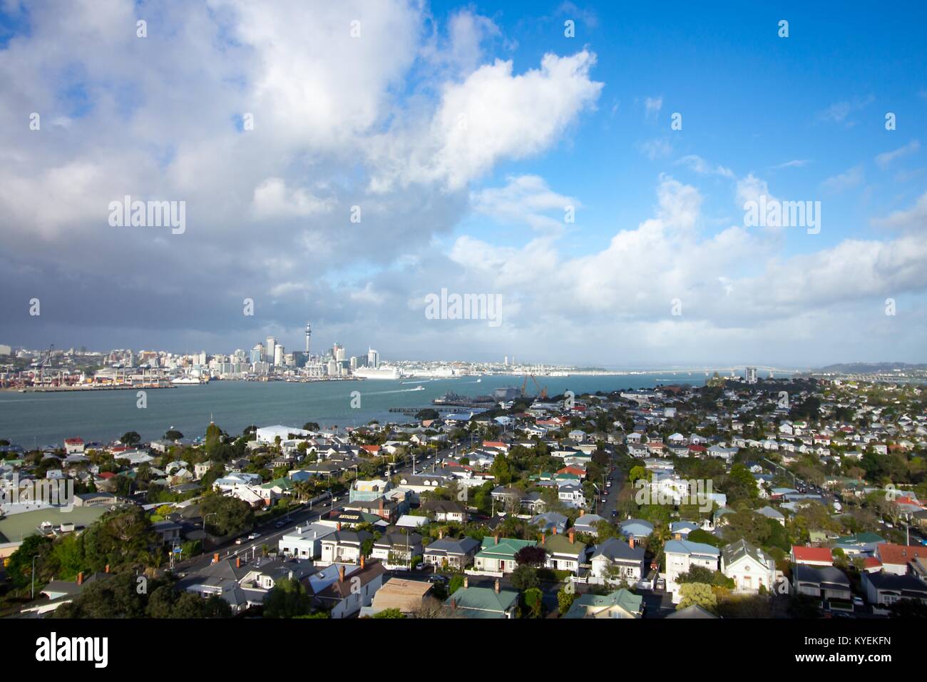 The urban skyline and surrounding neighborhoods of Auckland, New Zealand, as well as Auckland Harbor, are visible from Mount Victoria under a dramatic sky, October 11, 2017. () Stock Photo