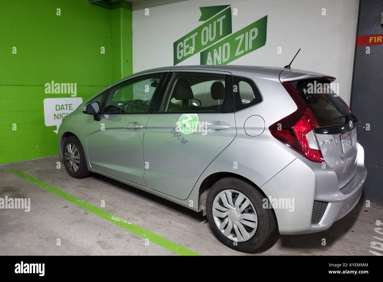 Zipcar car sharing vehicle parked under Zipcar signage in the South of