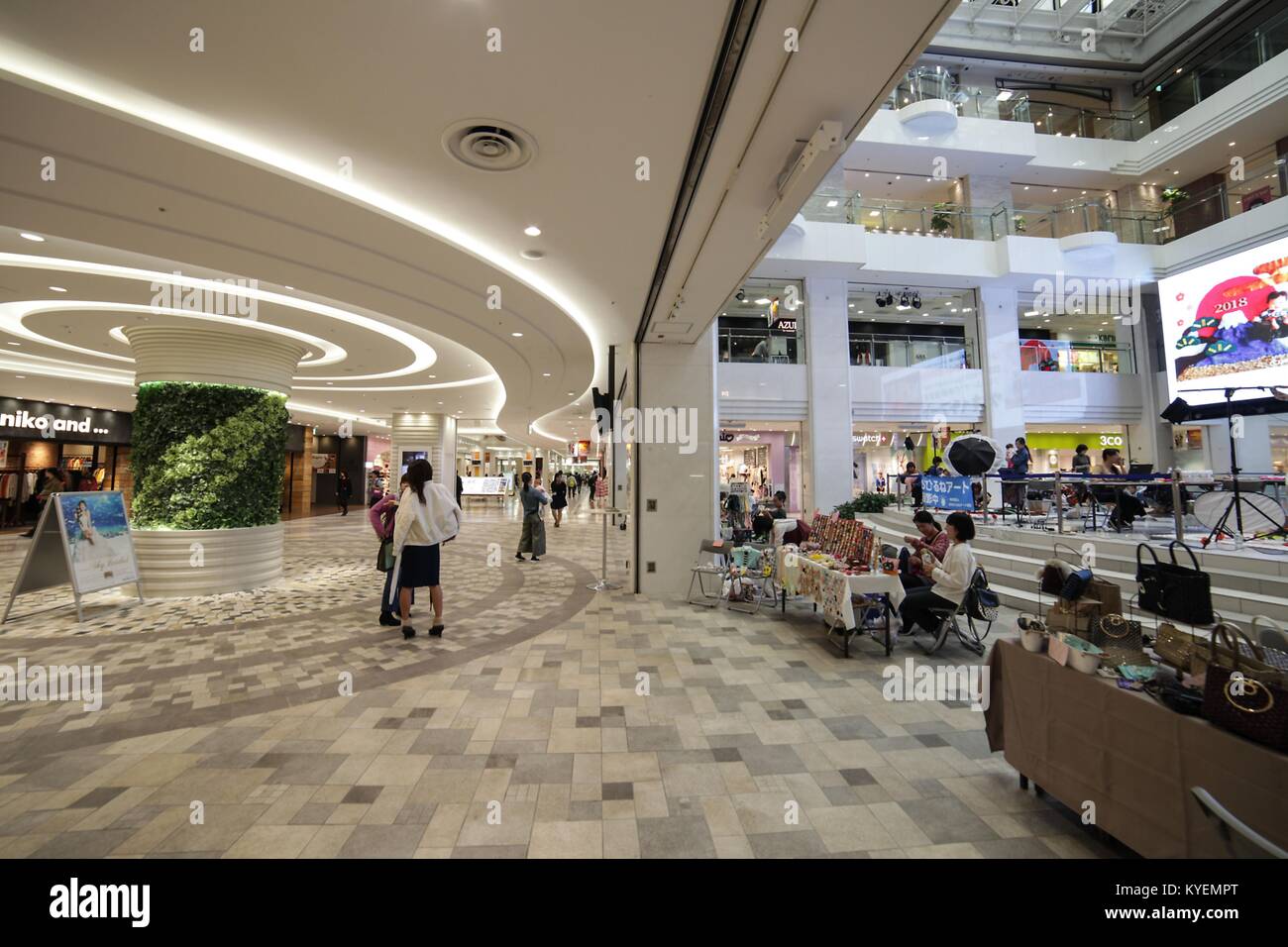 Shoppers walking through the interior of Ikebukuro Sunshine City, a shopping complex in the Ikebukuro ward, Toshima, Tokyo, Japan, October 16, 2017. () Stock Photo