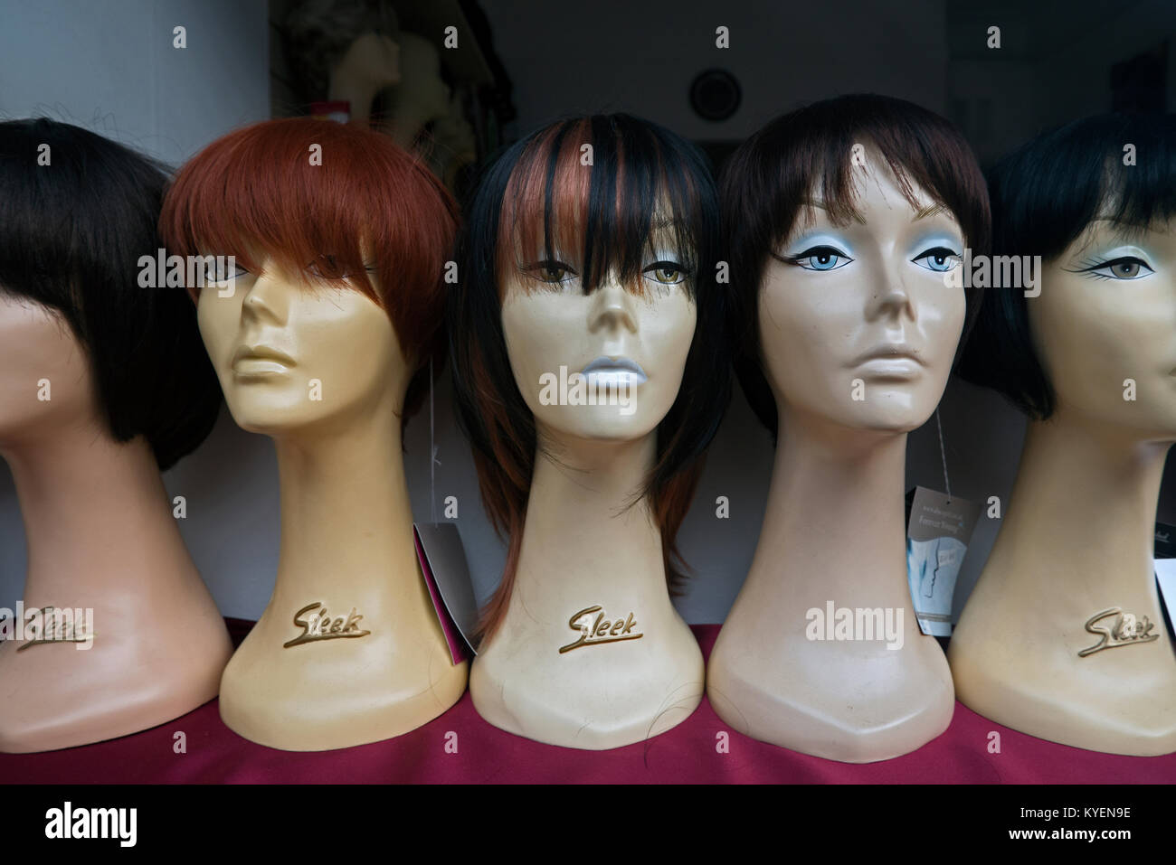 Female mannequin heads with wigs on display in a shop window in Edinburgh, Scotland, UK. Stock Photo