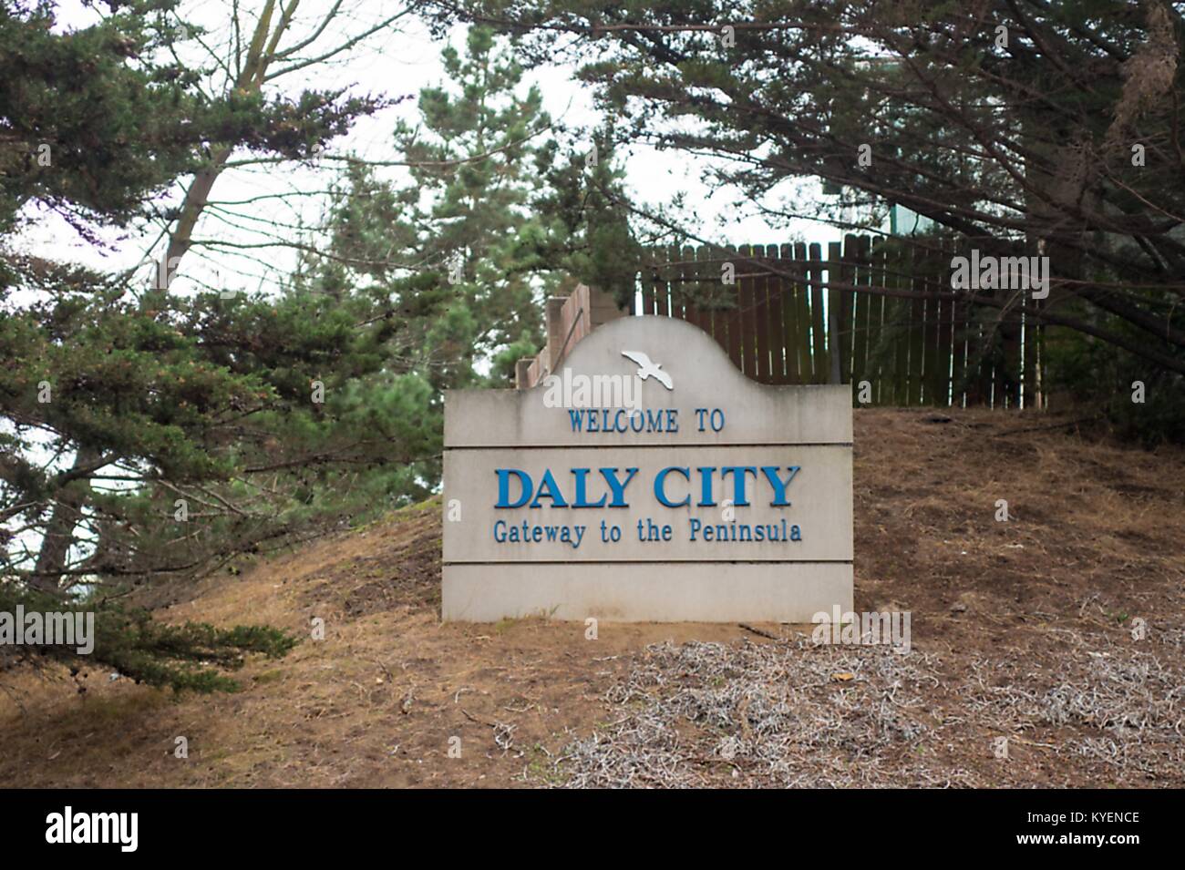 Sign reading Welcome to Daly City, Gateway to the Peninsula in a wooded center on the town line in the San Francisco Bay Area town of Daly City, California, November 3, 2017. () Stock Photo