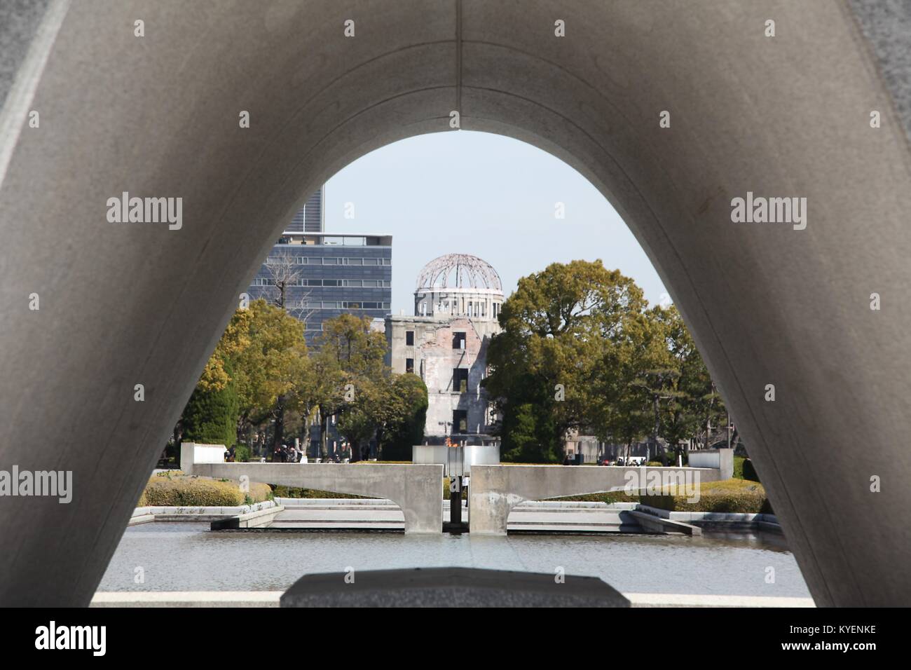 View through memorial statue at the Hiroshima Peace Memorial, part of the Hiroshima Peace Memorial Park, commemorating those who died in the atomic bombing of the city, Hiroshima, Japan, March 12, 2014. () Stock Photo