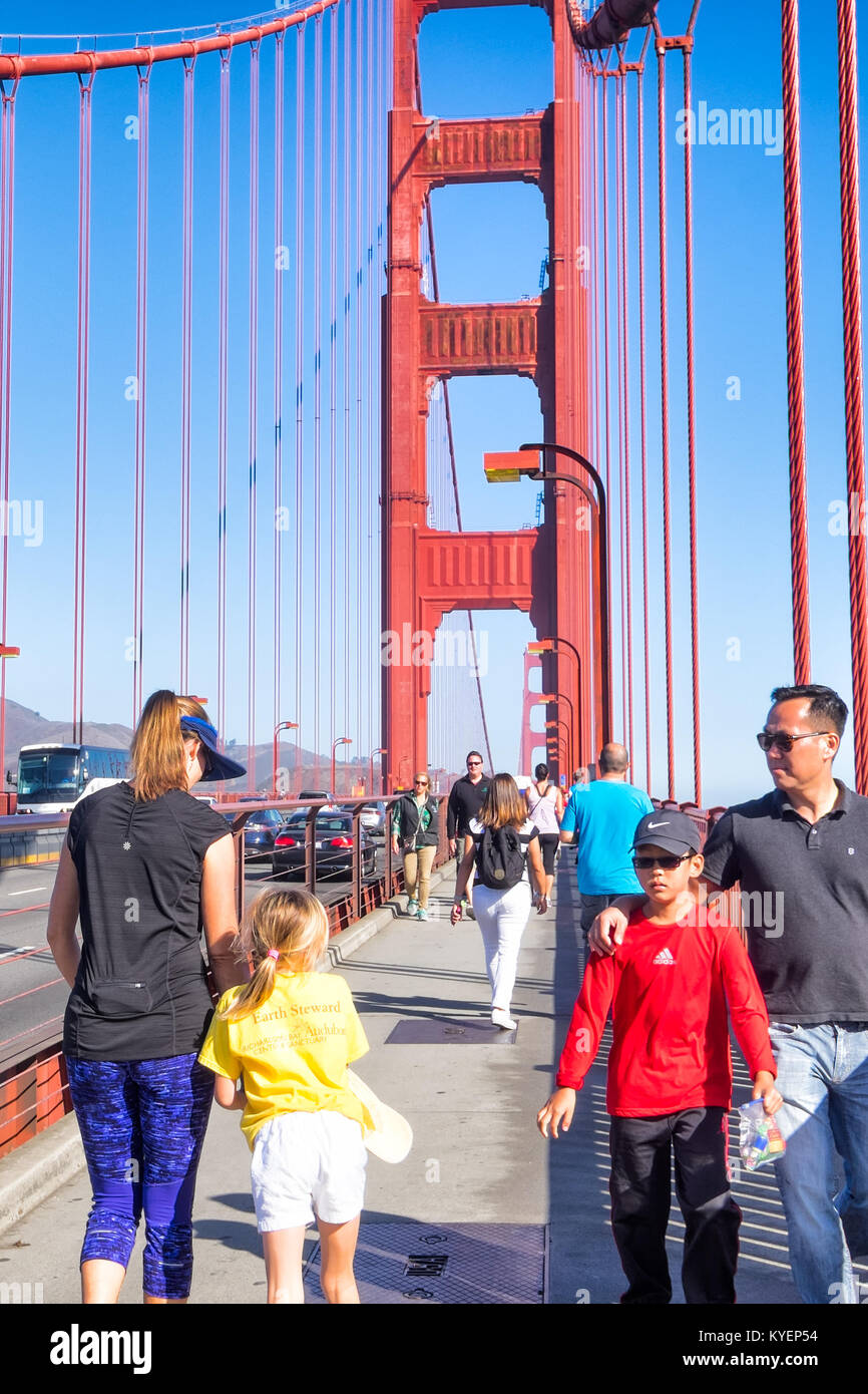 SAN FRANCISCO, CA- Oct.11, 2015: Golden Gate Bridge parents and kids shown walking across the span on the pedestrian lane. Popular activity. Sunny day Stock Photo