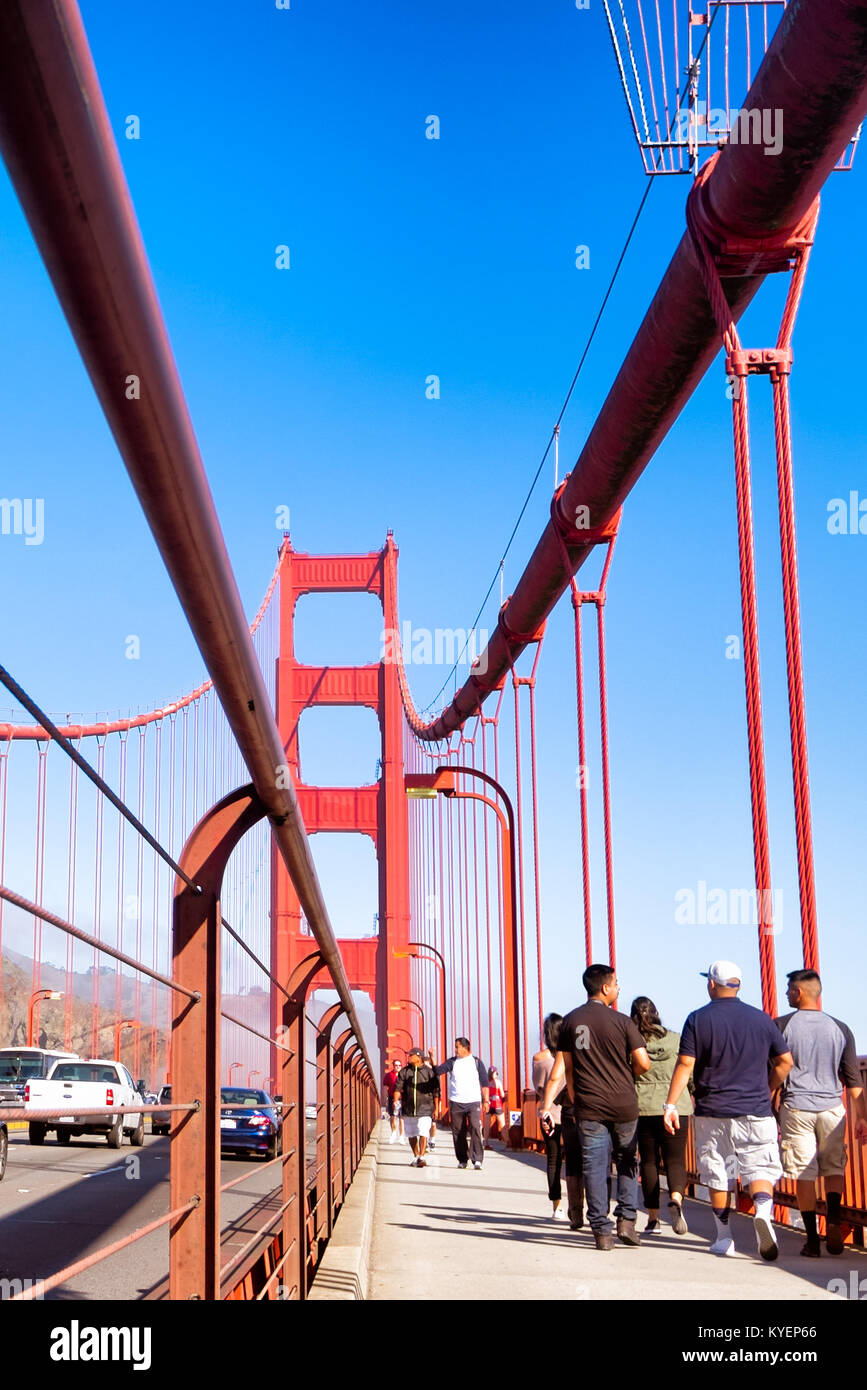 SAN FRANCISCO, CA- Oct. 11, 2015: Golden Gate Bridge on a clear sunny day. People walking across the bridge on the pedestrian lane. Copy space. Stock Photo