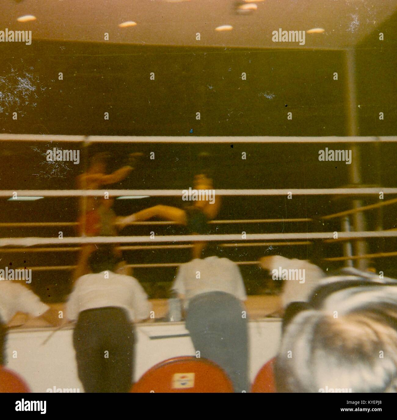 One fighter kicks another as people look on from ringside during a boxing match in Vietnam during the Vietnam War, 1968. () Stock Photo