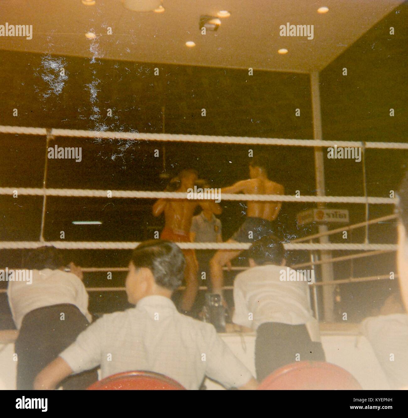 People gather around a ring to watch two fighters compete in a boxing match in Vietnam during the Vietnam War, 1968. () Stock Photo